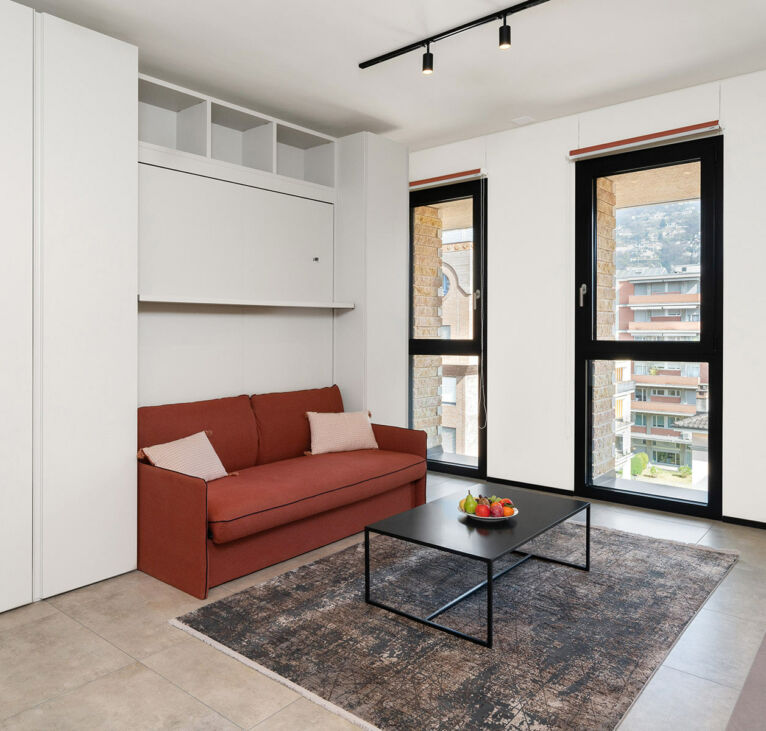 Sofa and windows with view on the Studio in Lugano Swiss Hotel Apartments