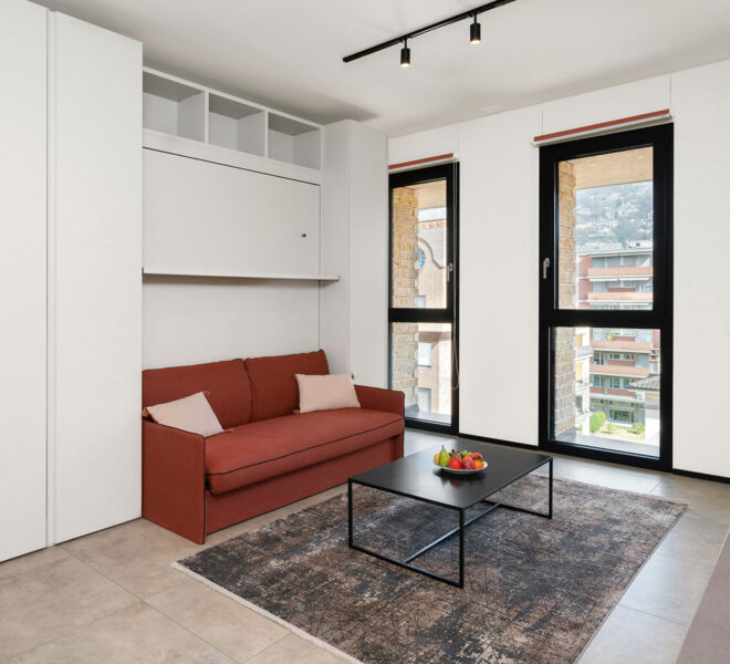 Sofa and windows with view on the Studio in Lugano Swiss Hotel Apartments